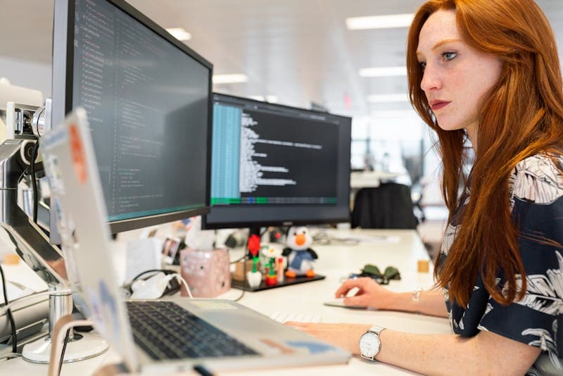 Software engineer working on identity verification code at her desk