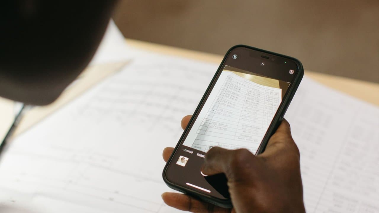 Person photographing a document with a smartphone