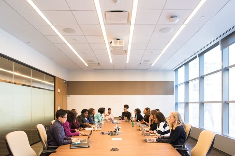 Executives aligning on governance and regulatory requirements in a conference room